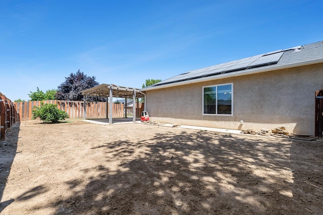 fenced backyard with a pergola and a patio