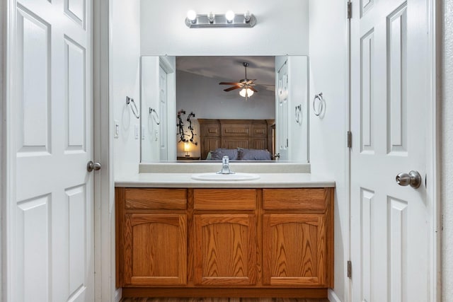 bathroom featuring ceiling fan, ensuite bathroom, and vanity