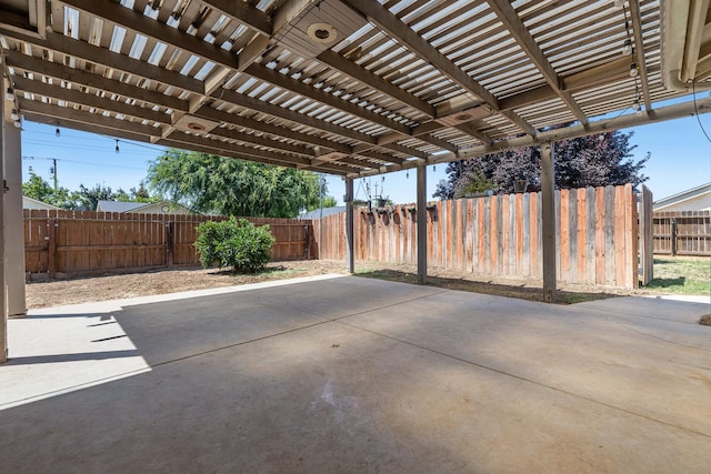 fenced backyard with a pergola and a patio area