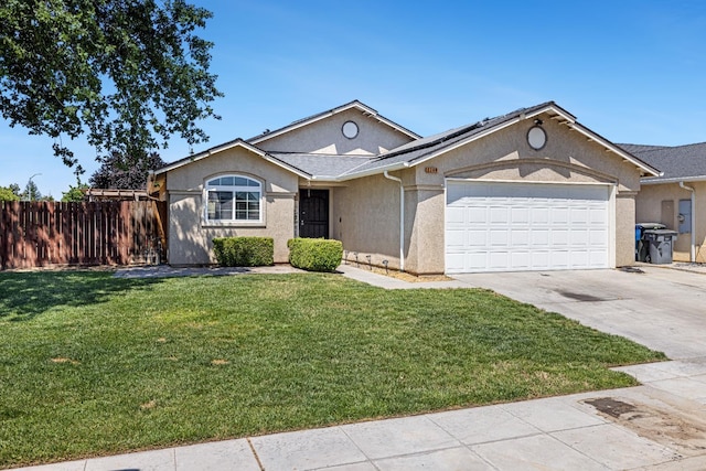 single story home with concrete driveway, a garage, stucco siding, and roof mounted solar panels