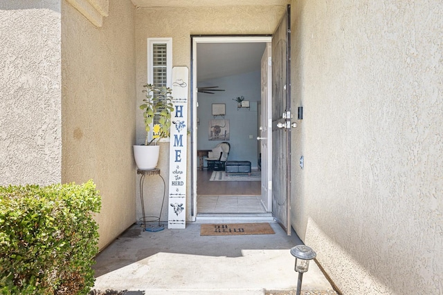 property entrance with stucco siding