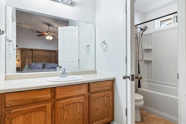 bathroom with ceiling fan, tile patterned floors, connected bathroom, vanity, and toilet