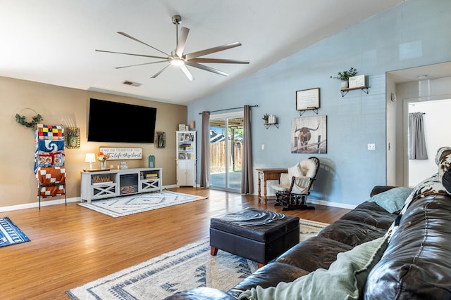 living area with ceiling fan, vaulted ceiling, wood finished floors, and baseboards