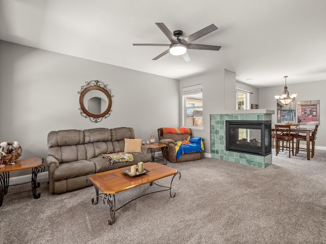 11340 N Via Milano Way, Fresno, CA 93730 - living room with carpet floors, a ceiling fan, a chandelier, a tile fireplace, and baseboards