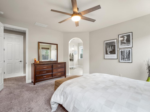 11340 N Via Milano Way, Fresno, CA 93730 - carpeted bedroom with arched walkways, a ceiling fan, connected bathroom, and baseboards