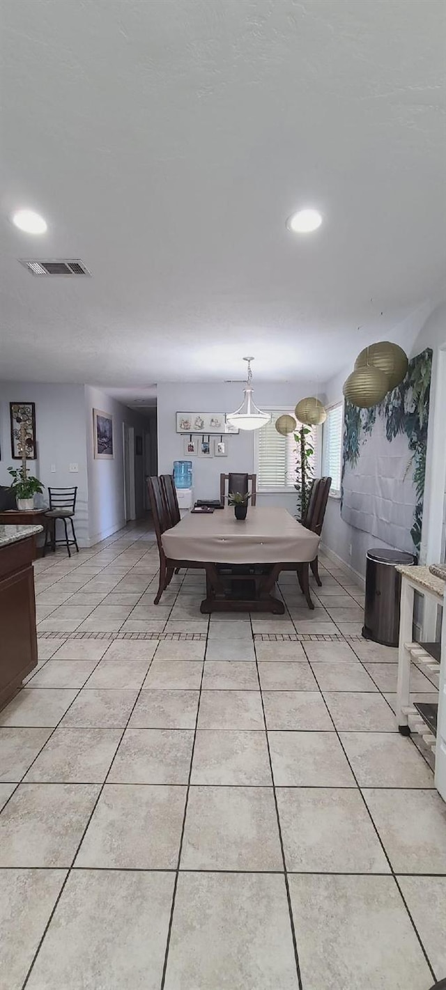dining area featuring light tile patterned floors, baseboards, and recessed lighting
