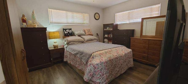 bedroom with dark wood-style flooring