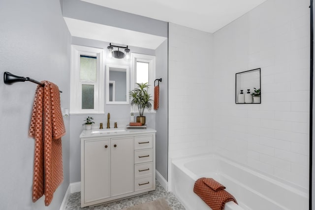 4918 E Illinois Ave, Fresno, CA 93727 - bathroom featuring baseboards, vanity, and shower / bath combination