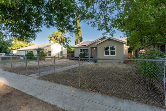 4918 E Illinois Ave, Fresno, CA 93727 - bungalow-style home with stucco siding and solar panels