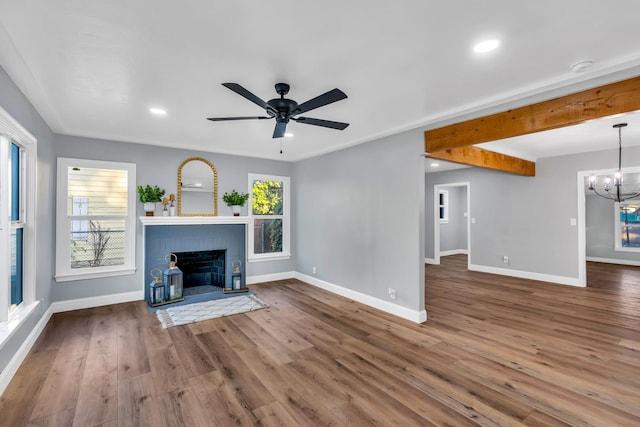 4918 E Illinois Ave, Fresno, CA 93727 - unfurnished living room with baseboards, wood finished floors, a brick fireplace, a ceiling fan, and recessed lighting