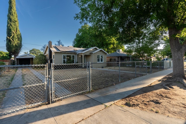 4918 E Illinois Ave, Fresno, CA 93727 - view of front of property featuring a gate, solar panels, and a chimney