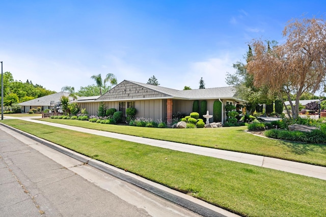 6608 N Haslam Ave, Fresno, CA 93711 - ranch-style home with a front yard and board and batten siding