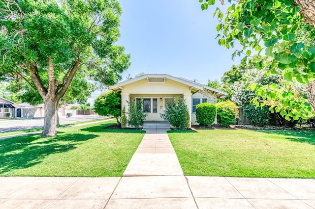 1934 N Vagedes Ave, Fresno, CA 93705 - bungalow with a front lawn and stucco siding