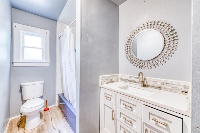 1934 N Vagedes Ave, Fresno, CA 93705 - full bath with wood finished floors, toilet, vanity, and shower / bath combo with shower curtain