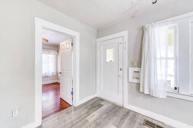 1934 N Vagedes Ave, Fresno, CA 93705 - foyer featuring wood finished floors, baseboards, and a textured ceiling