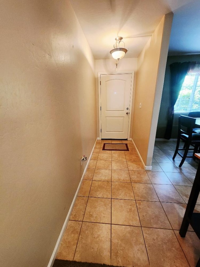 5788 E Mono St, Fresno, CA 93727 - doorway to outside with light tile patterned flooring and baseboards