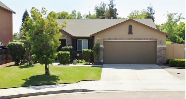 5788 E Mono St, Fresno, CA 93727 - ranch-style house with a garage, stone siding, concrete driveway, a front yard, and stucco siding