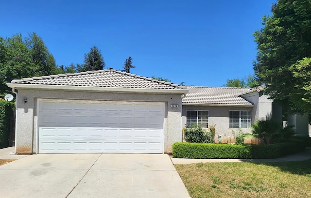 3426 W Tenaya Way, Fresno, CA 93711 - ranch-style home featuring a tile roof, stucco siding, driveway, and an attached garage