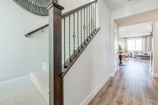 1165 Maclure Ave W, Madera, CA 93636 - staircase with wood finished floors and baseboards