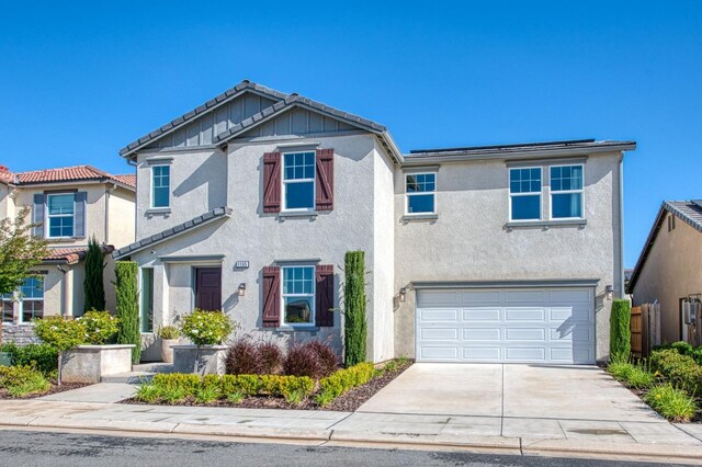 1165 Maclure Ave W, Madera, CA 93636 - view of front facade featuring an attached garage, stucco siding, a tiled roof, and concrete driveway