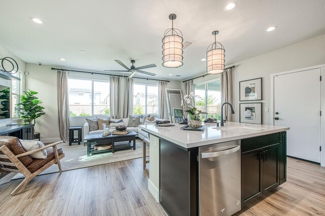 1165 Maclure Ave W, Madera, CA 93636 - kitchen with stainless steel dishwasher, open floor plan, a sink, recessed lighting, and light countertops