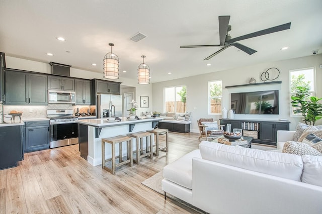 1165 Maclure Ave W, Madera, CA 93636 - living area with plenty of natural light, a ceiling fan, recessed lighting, and light wood-style floors
