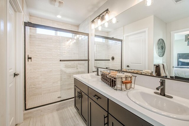 1165 Maclure Ave W, Madera, CA 93636 - bathroom with connected bathroom, a shower stall, and double vanity