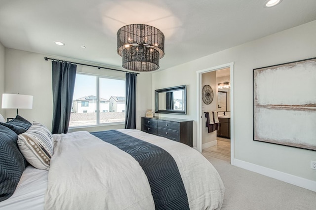 1165 Maclure Ave W, Madera, CA 93636 - bedroom with a chandelier, light colored carpet, baseboards, recessed lighting, and connected bathroom