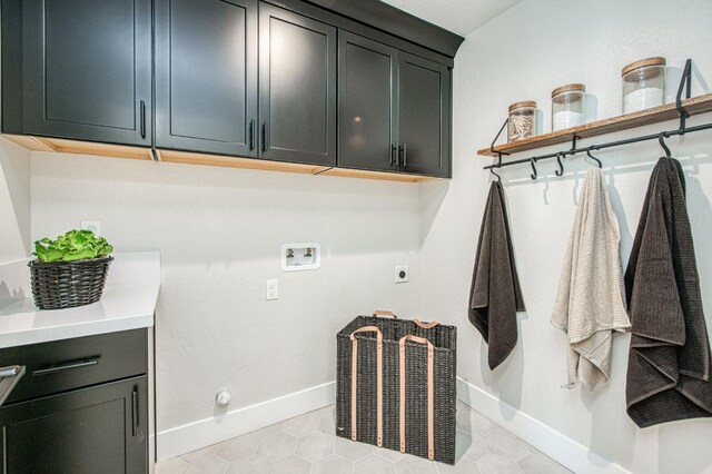 1165 Maclure Ave W, Madera, CA 93636 - laundry room with cabinet space, hookup for a washing machine, electric dryer hookup, and baseboards