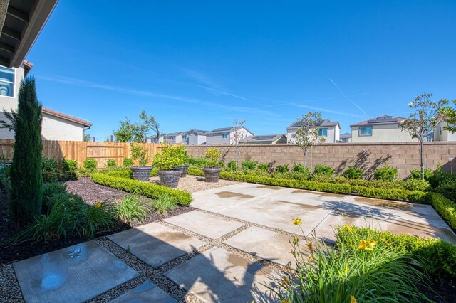 1165 Maclure Ave W, Madera, CA 93636 - fenced backyard featuring a patio area and a residential view