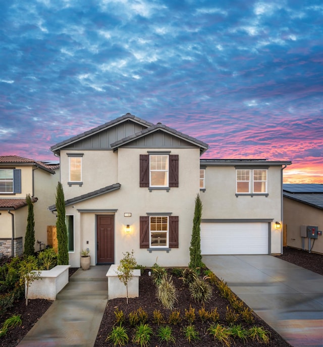 1165 Maclure Ave W, Madera, CA 93636 - traditional-style house with an attached garage, concrete driveway, stucco siding, and board and batten siding