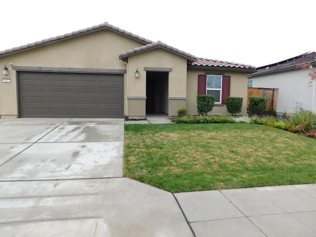 865 S Bridle Ave, Fresno, CA 93727 - ranch-style house featuring stucco siding, concrete driveway, a tiled roof, an attached garage, and a front yard