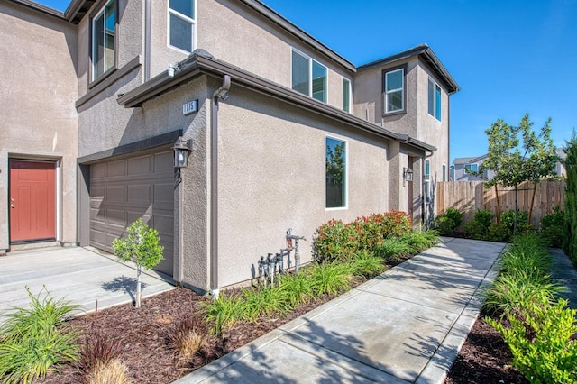 1175 Maclure Ave W, Madera, CA 93636 - view of home's exterior featuring an attached garage and stucco siding