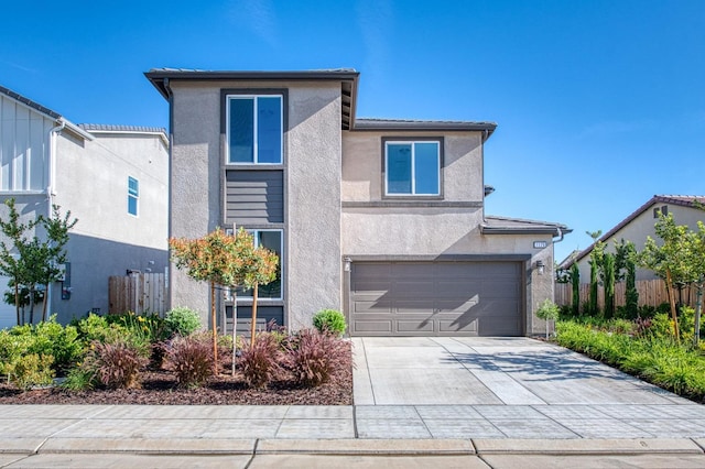 1175 Maclure Ave W, Madera, CA 93636 - view of front facade with stucco siding, an attached garage, and driveway