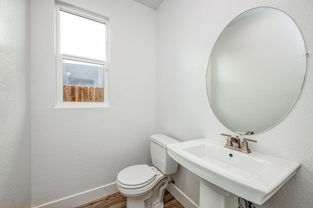 1175 Maclure Ave W, Madera, CA 93636 - bathroom with wood finished floors, a sink, toilet, and baseboards