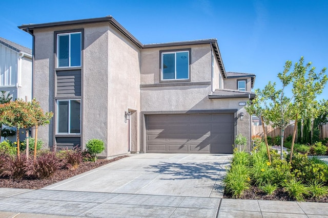 1175 Maclure Ave W, Madera, CA 93636 - view of front of house with an attached garage, stucco siding, and concrete driveway