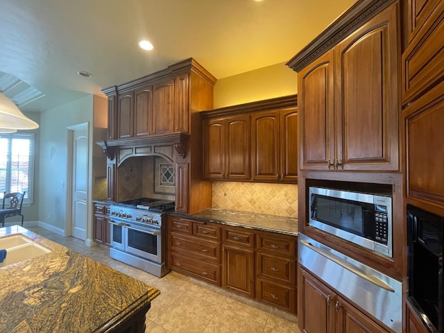 16052 W Middleton Ave, Kerman, CA 93630 - kitchen with stainless steel appliances, a warming drawer, decorative backsplash, light tile patterned floors, and recessed lighting