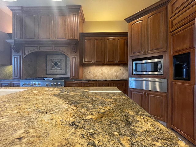 16052 W Middleton Ave, Kerman, CA 93630 - kitchen with a warming drawer, stainless steel microwave, dark stone counters, backsplash, and stove