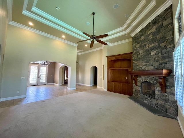 16052 W Middleton Ave, Kerman, CA 93630 - unfurnished living room with arched walkways, ceiling fan, carpet floors, a stone fireplace, and crown molding