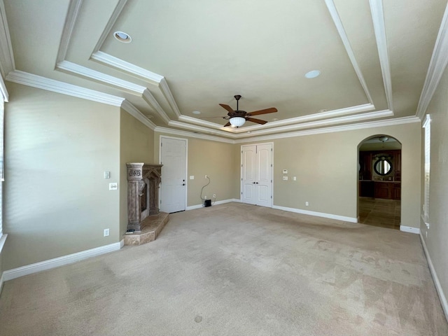 16052 W Middleton Ave, Kerman, CA 93630 - unfurnished living room featuring a tray ceiling, crown molding, ceiling fan, a fireplace with raised hearth, and light colored carpet