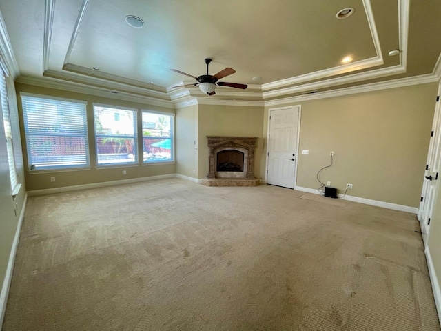 16052 W Middleton Ave, Kerman, CA 93630 - unfurnished living room featuring a tray ceiling, ornamental molding, baseboards, light colored carpet, and a ceiling fan