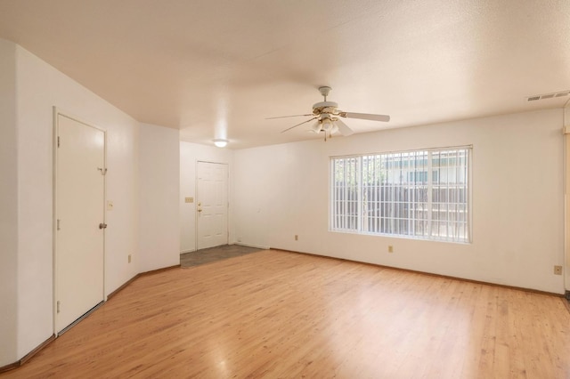 2063 S Tupman Ave, Fresno, CA 93706 - unfurnished room with light wood-style flooring, ceiling fan, and baseboards
