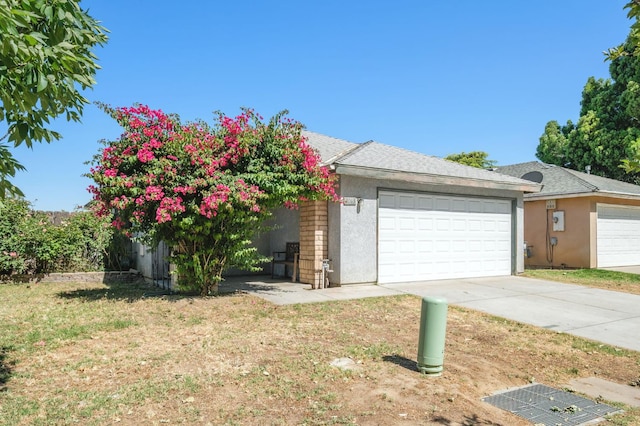 2063 S Tupman Ave, Fresno, CA 93706 - view of front of property featuring a garage, stucco siding, and a front lawn
