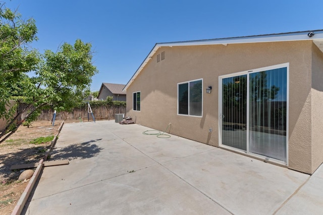 fenced backyard featuring a patio area and central air condition unit