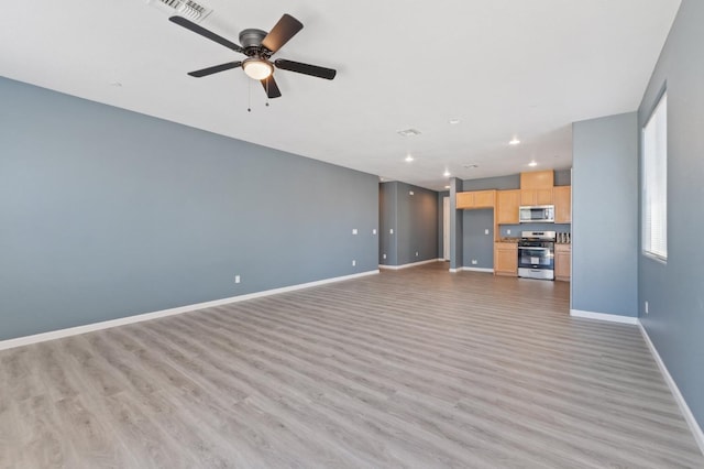 unfurnished living room featuring baseboards, light wood-style floors, a ceiling fan, and recessed lighting