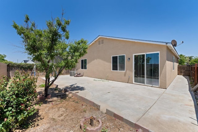 back of property with stucco siding, a fenced backyard, and a patio area