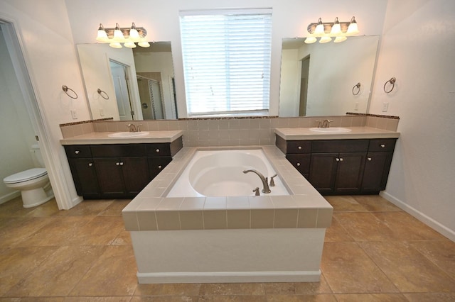 full bath with a stall shower, a bath, baseboards, and two vanities