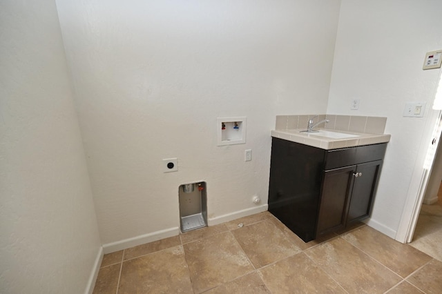 washroom with hookup for an electric dryer, washer hookup, cabinet space, baseboards, and light tile patterned floors