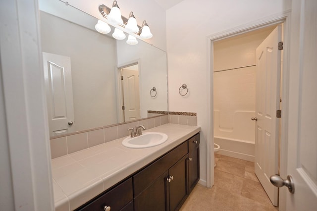 bathroom with toilet, vanity, and washtub / shower combination