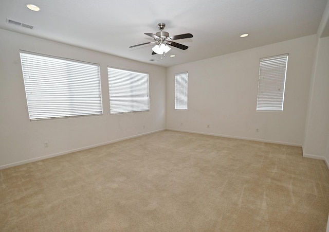 unfurnished room with light carpet, a ceiling fan, baseboards, and recessed lighting